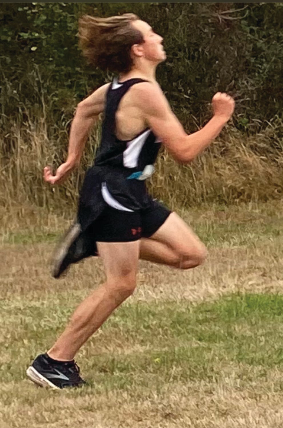 Grady White gives it his all in winning his third cross country race of the season.